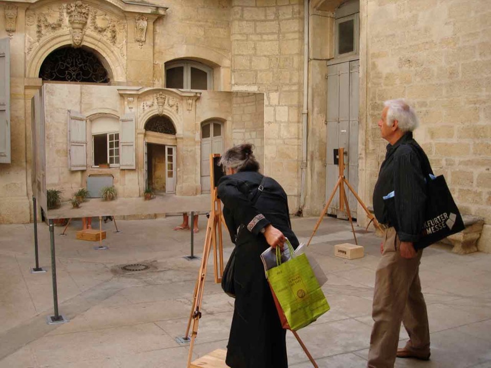 Visitors of the project looking through the camera device to read the installation in alignment with the context.