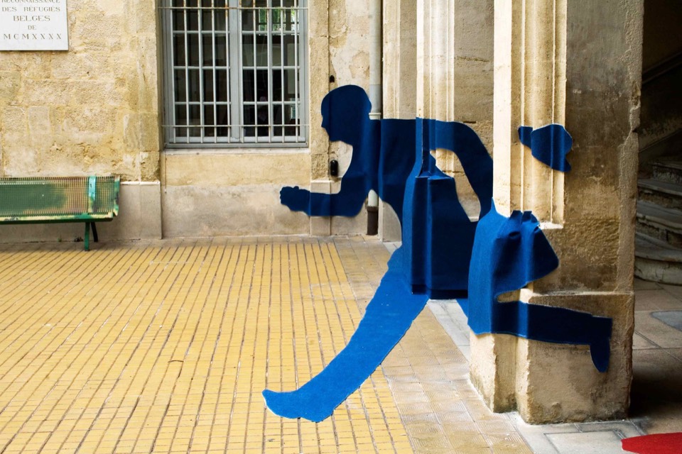 Dynamic human silouettes stuck on to the interior courtyard surfaces.