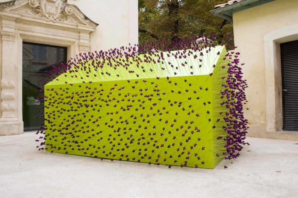 Bright green hexagon embellished with purple roses in the center of the courtyard.