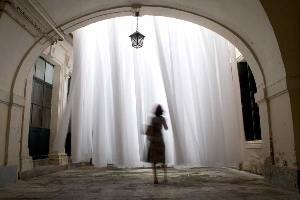 Suspended white fabric elements engulfing the interior courtyard.