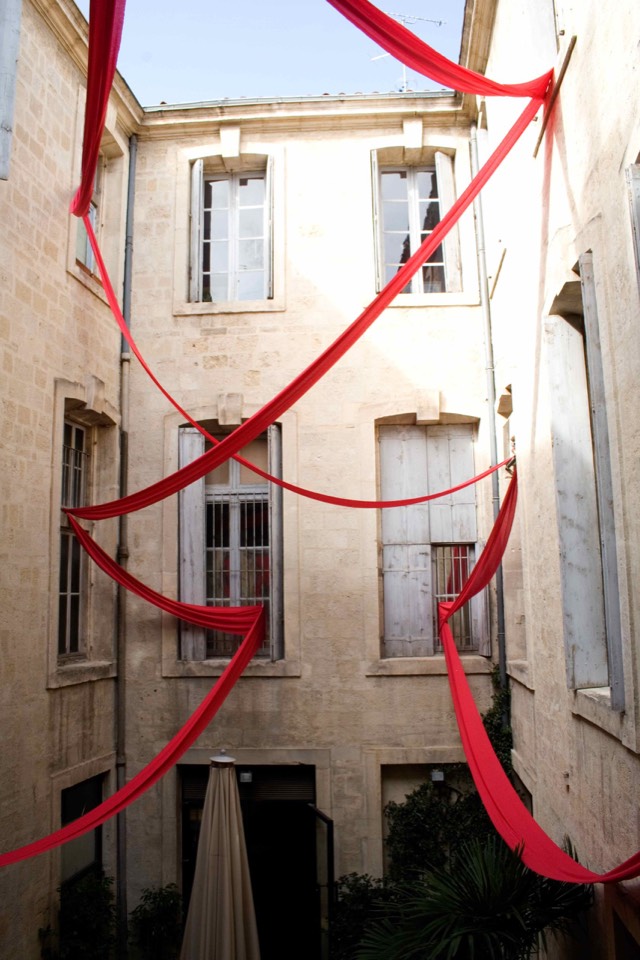 Red ribbon suspended in the courtyard.